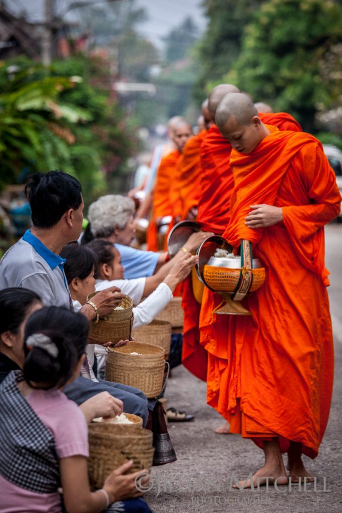Each morning in Luang Prabang, Laos Buddhist monks carry out the morning alms procession.