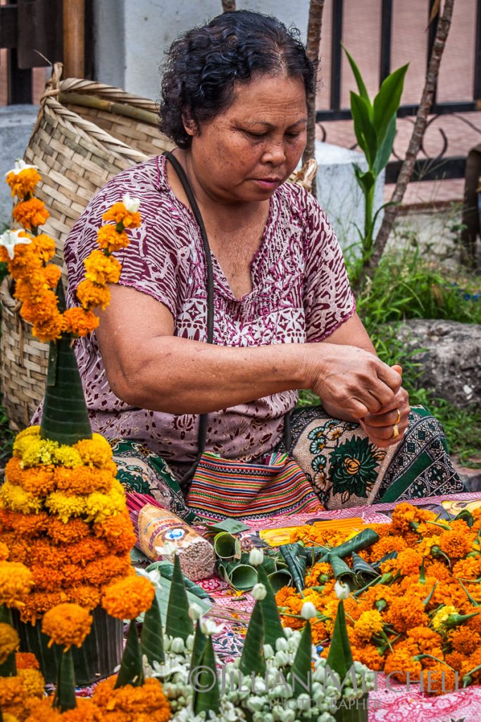 Woman making Mak Beng a traditional spiritual Buddhist offering, Luang Prabang